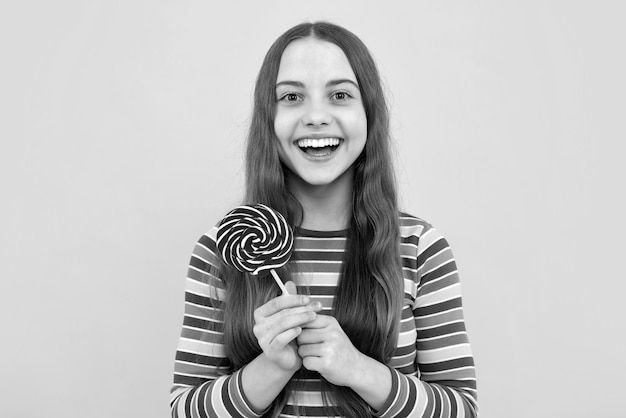 Hipster teenager child girl lick lollypop Sugar nutrition candy and sweets Child eat lollipop popsicle