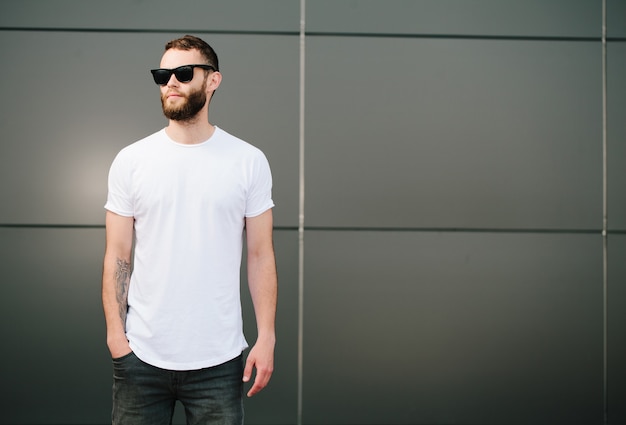 Hipster wearing white blank t-shirt with space for your logo