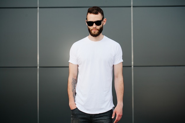 Hipster wearing white blank t-shirt with space for your logo