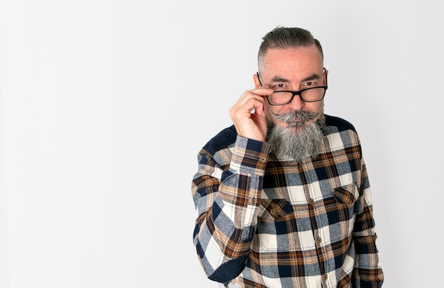 Hipster with gray beard, plaid shirt and serious look