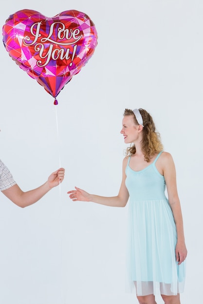 Hipster woman having heart balloon 