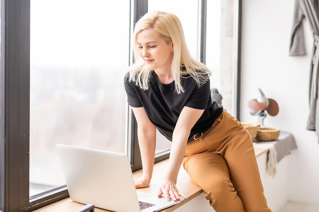 Hipster woman use Laptop huge Loft Studio. Student Researching Process Work. Young Business Woman Working Creative Startup modern Office. Analyze market stock, new strategy.