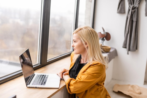 Hipster woman use laptop huge loft studio. student researching\
process work. young business woman working creative startup modern\
office. analyze market stock, new strategy.