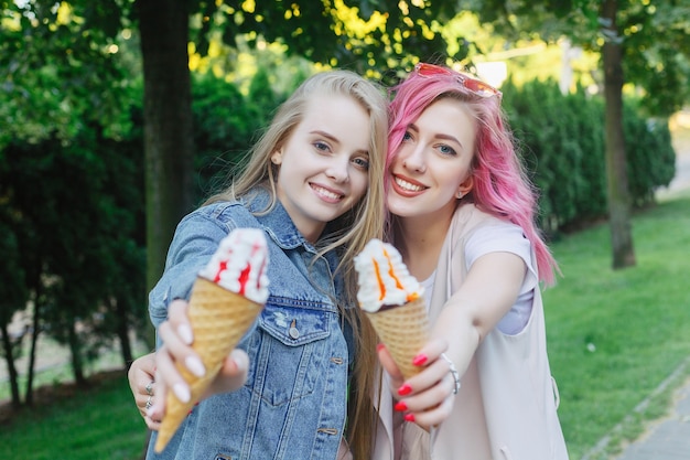 Hipster young adult friends embracing while hanging out in the city