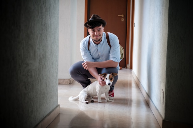 hipster young man posing with jack russell dog