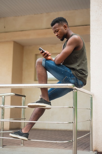 Hipster, a young man using a smartphone