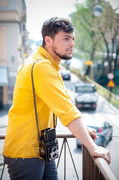 hipster young man with old camera