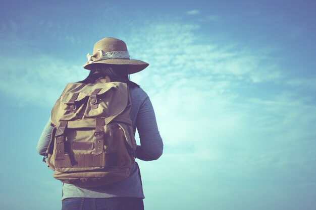 Hipster young woman with backpack enjoying