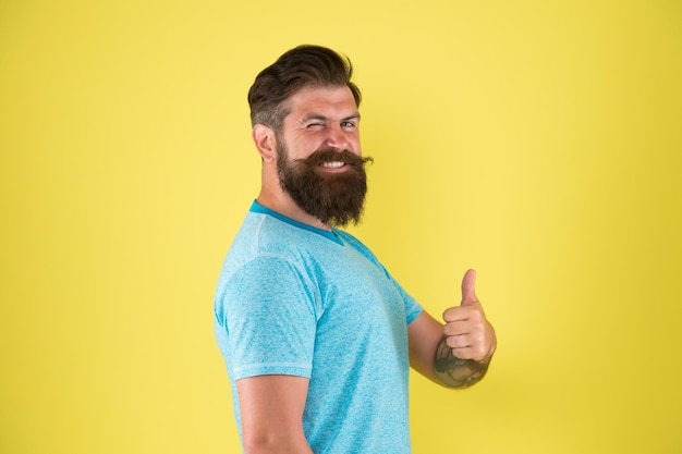 His barber is the best Bearded man showing thumbs up after visiting barber Happy hipster gesturing like to barber shop Grooming a beard at master barber
