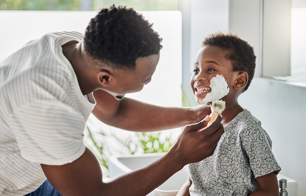 His first shaving lesson with Dad Shot of a father applying shaving cream to his sons face in a bathroom at home