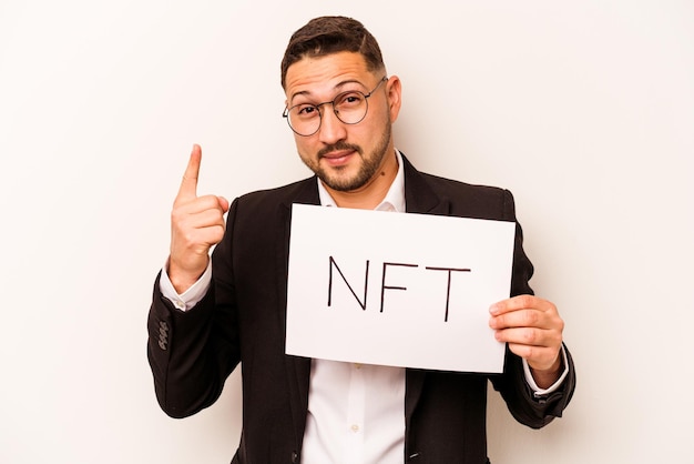 Hispanic business man holding a nft placard isolated on white background