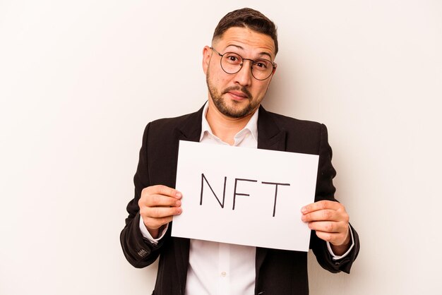 Hispanic business man holding a nft placard isolated on white background