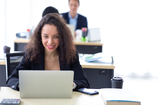 Hispanic business woman busy working laptop computer at office