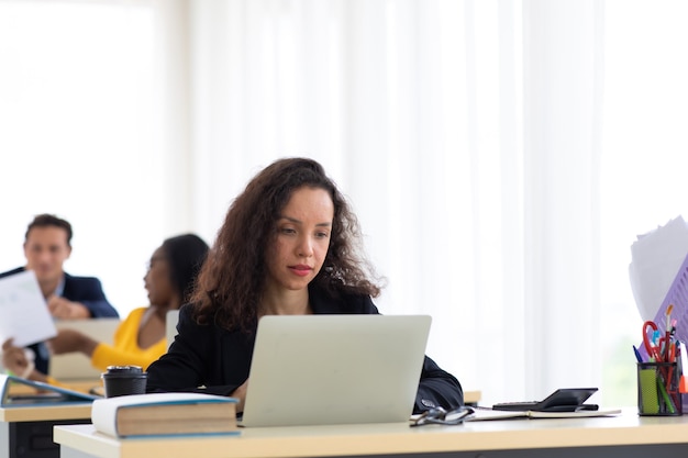 Hispanic business woman busy working laptop computer at office