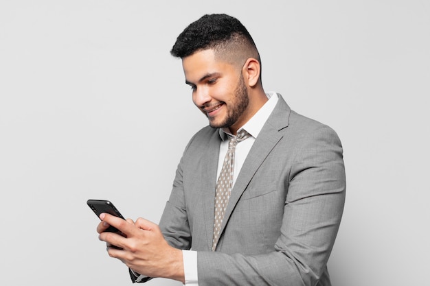 hispanic businessman happy expression and holding a phone