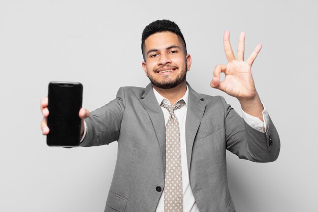 Hispanic businessman happy expression and holding a phone