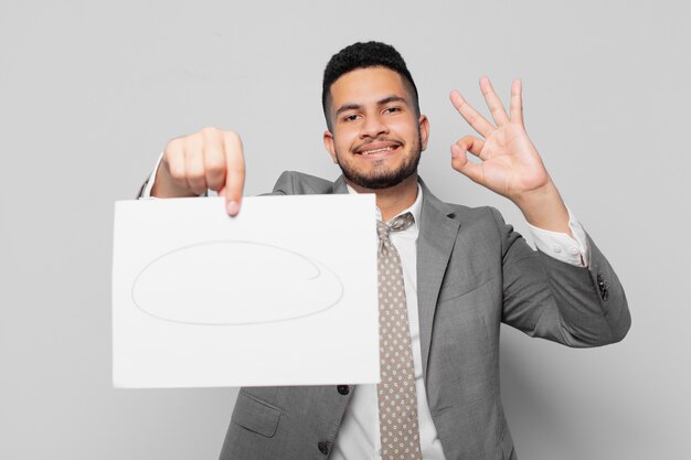 Hispanic businessman happy expression and holding a sheet of paper