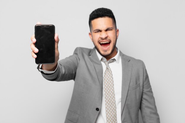 Hispanic businessman thinking expression and holding a phone