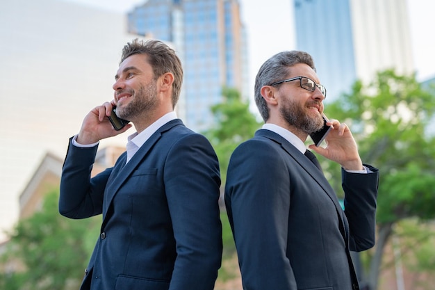 Hispanic businessmen using smartphone at the city handsome business men in suit calling mobile phone