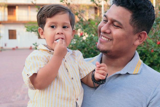 Hispanic father and son spend a day together in the park