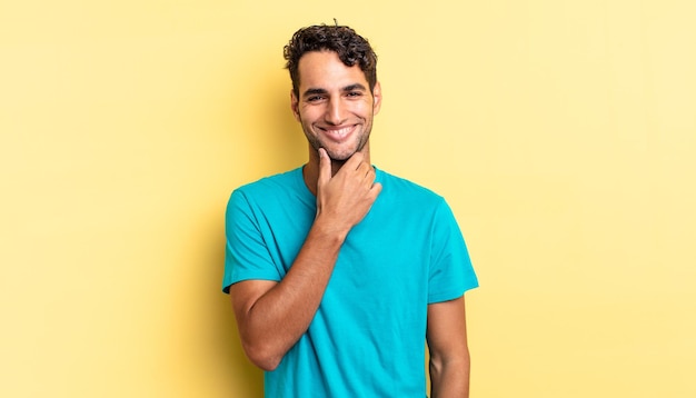 Hispanic handsome man smiling, enjoying life, feeling happy