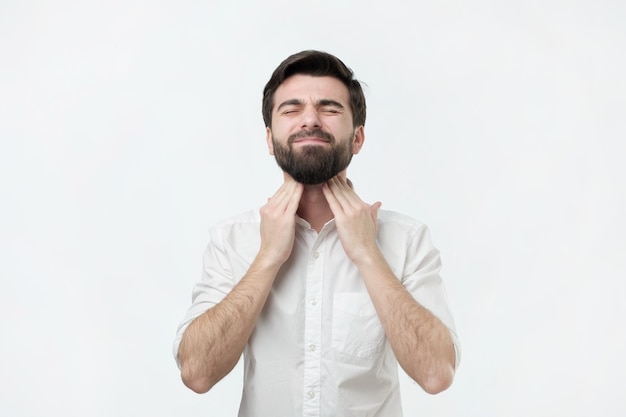 Hispanic man checks swollen lymph nodes in the neck