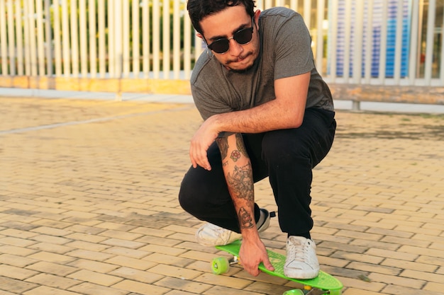 Hispanic man skateboarding in an urban park as a hobby