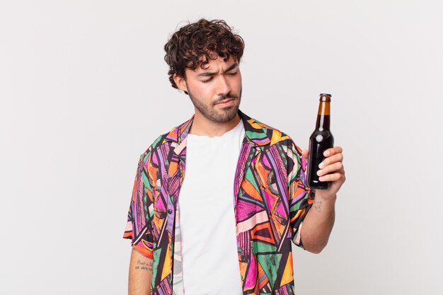 Hispanic man with beer feeling sad, upset or angry and looking to the side with a negative attitude, frowning in disagreement