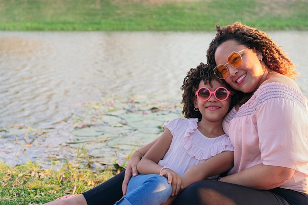 Hispanic Mother With Their Daughter Enjoying Picnic