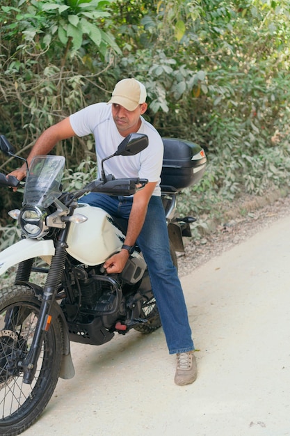 Hispanic motorcyclist who starts his journey after resting