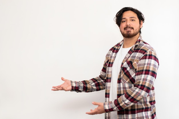 Photo hispanic person making gesture of indication to the left empty space in white background