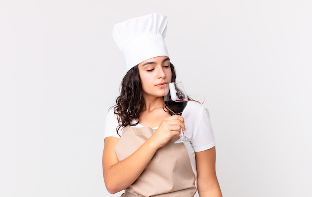 Hispanic pretty chef woman holding a glass of wine