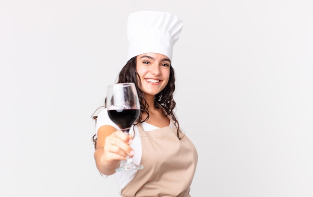 Hispanic pretty chef woman holding a glass of wine