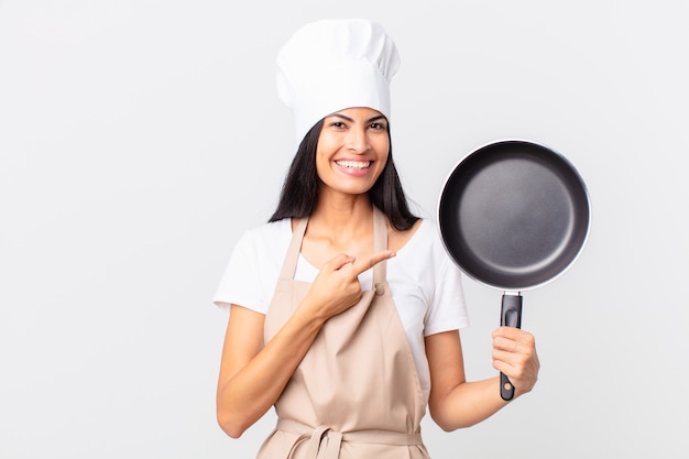 Hispanic pretty chef woman holding a pan