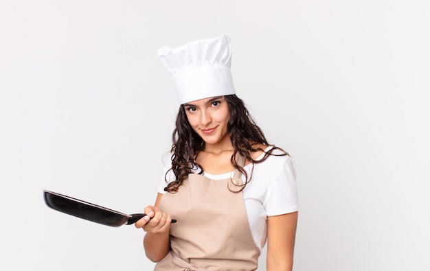 Hispanic pretty chef woman holding a pan