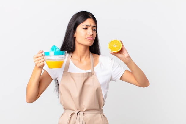 Hispanic pretty chef woman. orange juice and breakfast concept