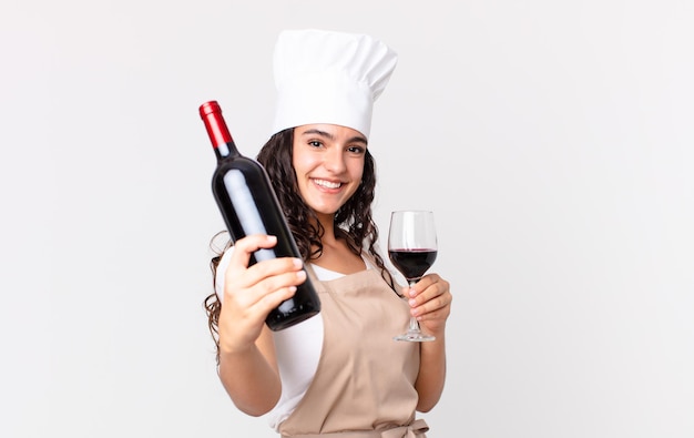 Hispanic pretty chef woman with a bottle of wine