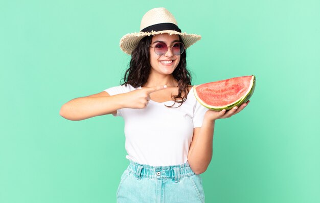 Hispanic pretty tourist woman holding a watermelon