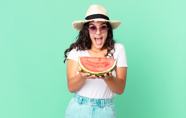 Hispanic pretty tourist woman holding a watermelon