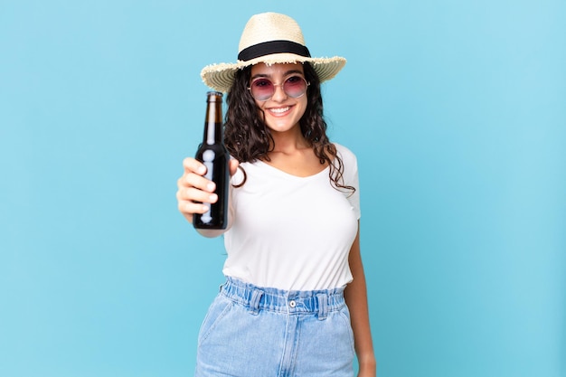 Hispanic pretty traveler woman with a bottle of beer