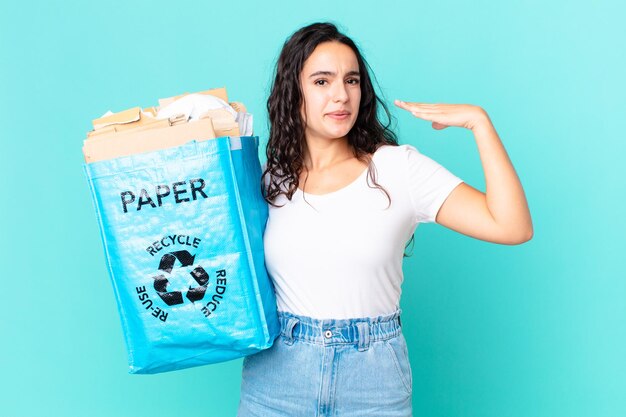 Hispanic pretty woman feeling stressed anxious tired and frustrated and holding a recycled paper bag