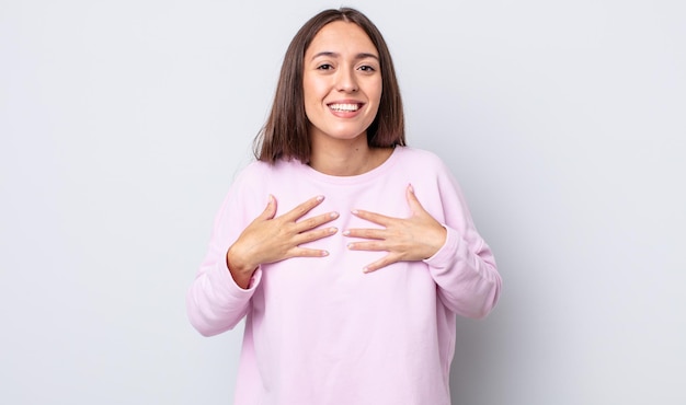 Hispanic pretty woman looking happy surprised proud and excited pointing to self