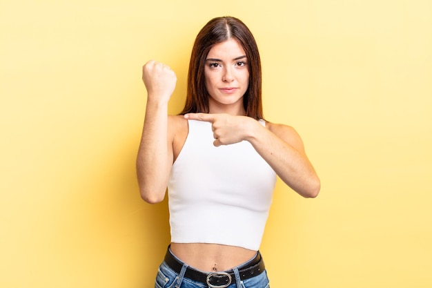 Hispanic pretty woman looking impatient and angry, pointing at watch, asking for punctuality, wants to be on time