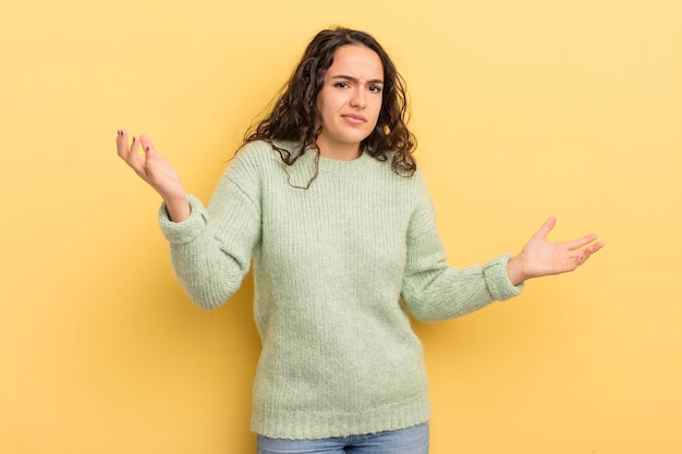 Hispanic pretty woman looking puzzled confused and stressed wondering between different options feeling uncertain