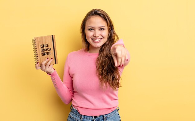 Hispanic pretty woman pointing at camera choosing you recycle concept