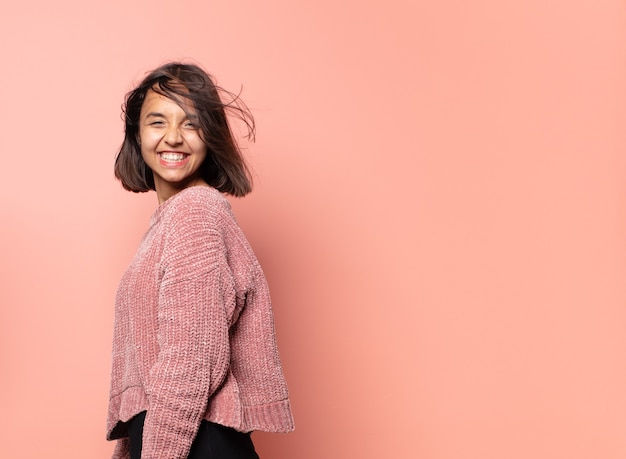 Hispanic pretty woman posing on pink