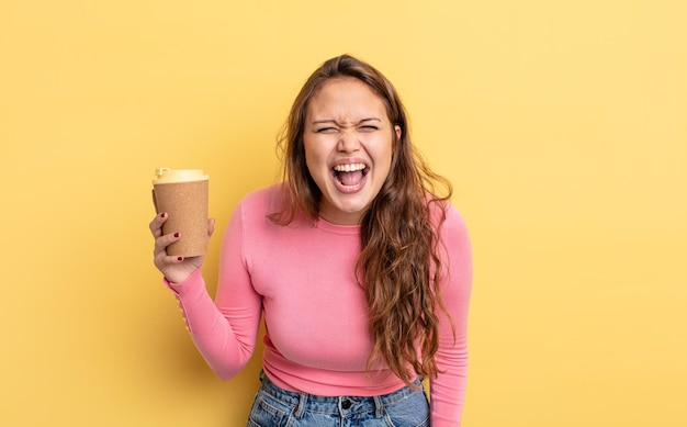 Hispanic pretty woman shouting aggressively looking very angry take away coffee concept