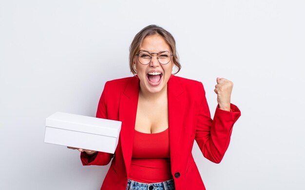 Hispanic pretty woman shouting aggressively with an angry expression package product concept