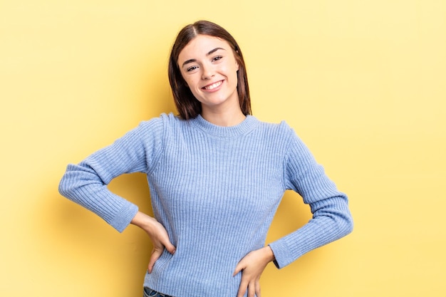 Hispanic pretty woman smiling cheerfully and casually with a positive happy confident and relaxed expression