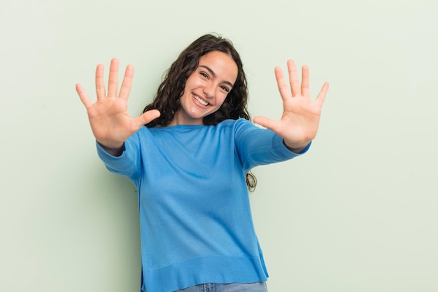 히스패닉계 예쁜 여성이 웃고 손을 앞으로 카운트다운하면서 10번 또는 10번을 보여주는 친근한 모습